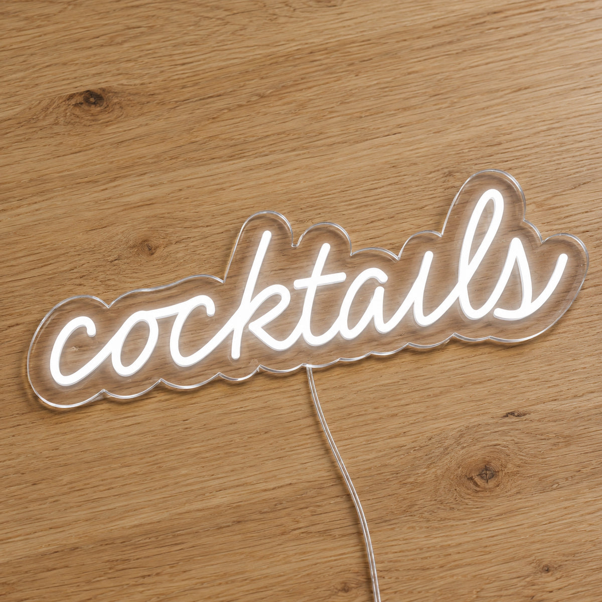 Cocktails LED Neon Sign - Bar and Venue Sign in white, featuring Cocktails script lettering on a wooden surface.