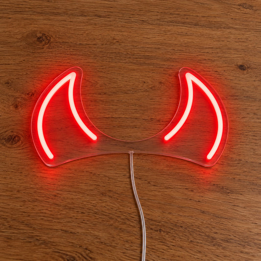 Horns LED Neon Light Sign in red, featuring pair of devil-horn outlines on a wooden surface.