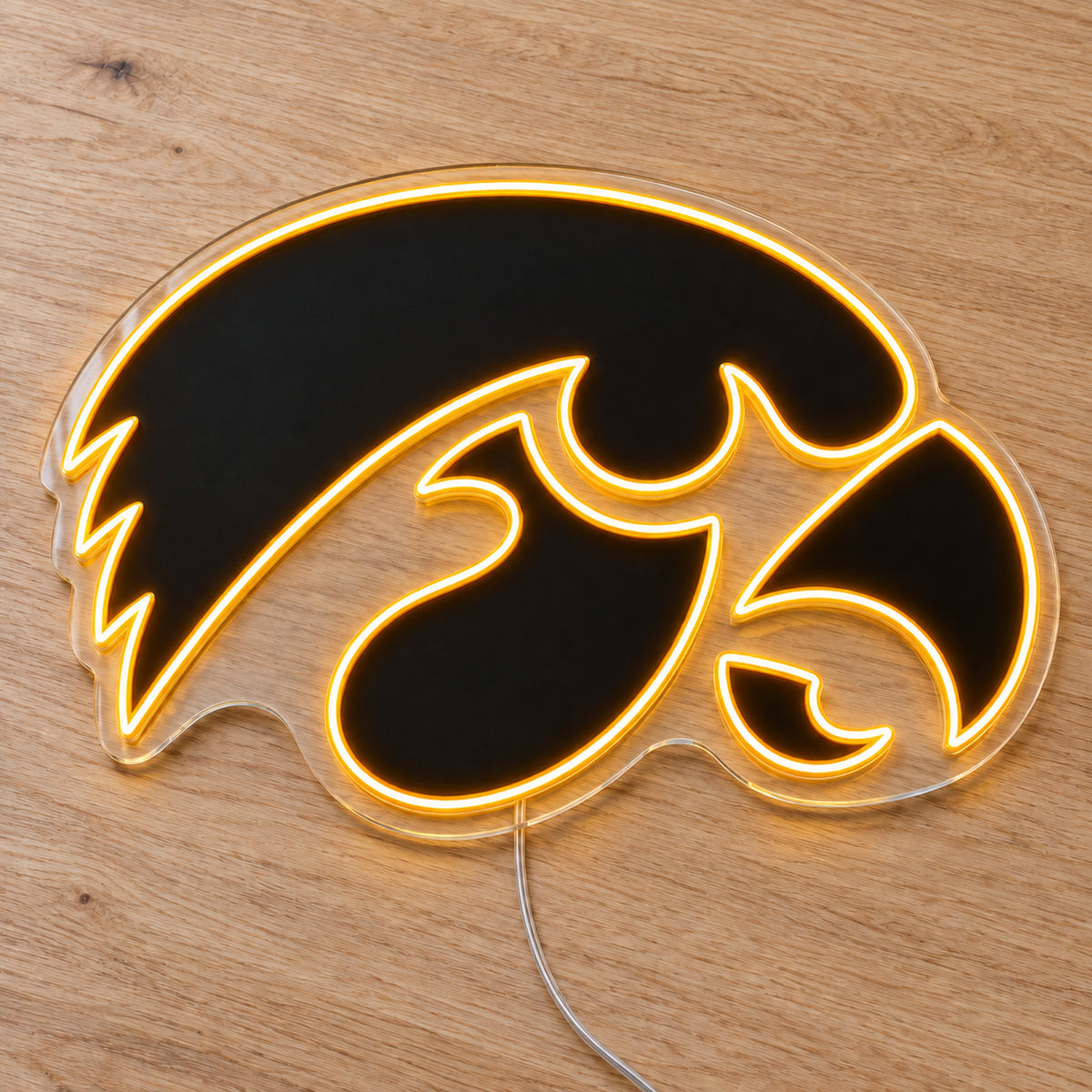 Iowa Hawkeyes LED Neon Sign, featuring team logo displayed on a wooden surface.