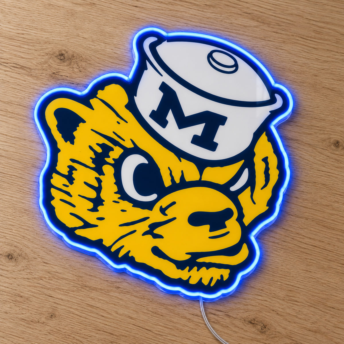 Michigan Wolverines Retro Mascot LED Neon Sign, featuring team logo displayed on a wooden surface.
