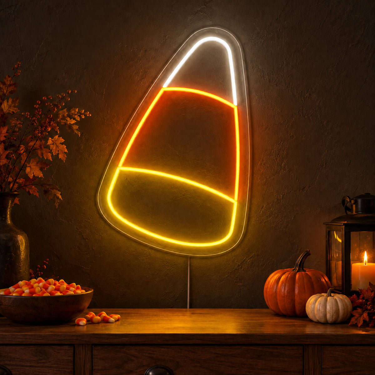 Candy Corn Neon Sign featuring a candy corn outline divided into white, orange and yellow sections, glowing on a dark wall in a Halloween room display.