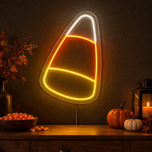 Candy Corn Neon Sign featuring a candy corn outline divided into white, orange and yellow sections, glowing on a dark wall in a Halloween room display.