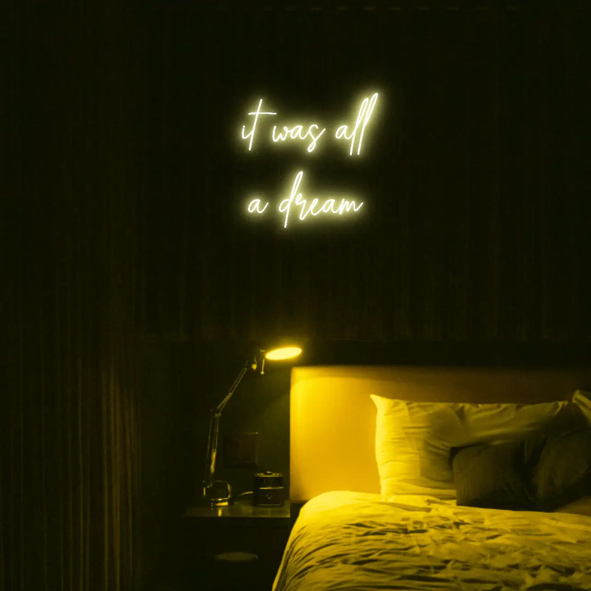 It Was All a Dream LED Neon Light Sign in yellow, featuring script lettering illuminated above a bed.