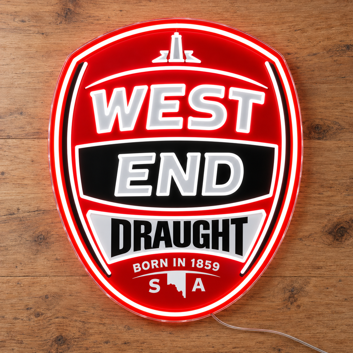 West End Draught Neon Sign, featuring illuminated beer-brand logo on a wooden surface.