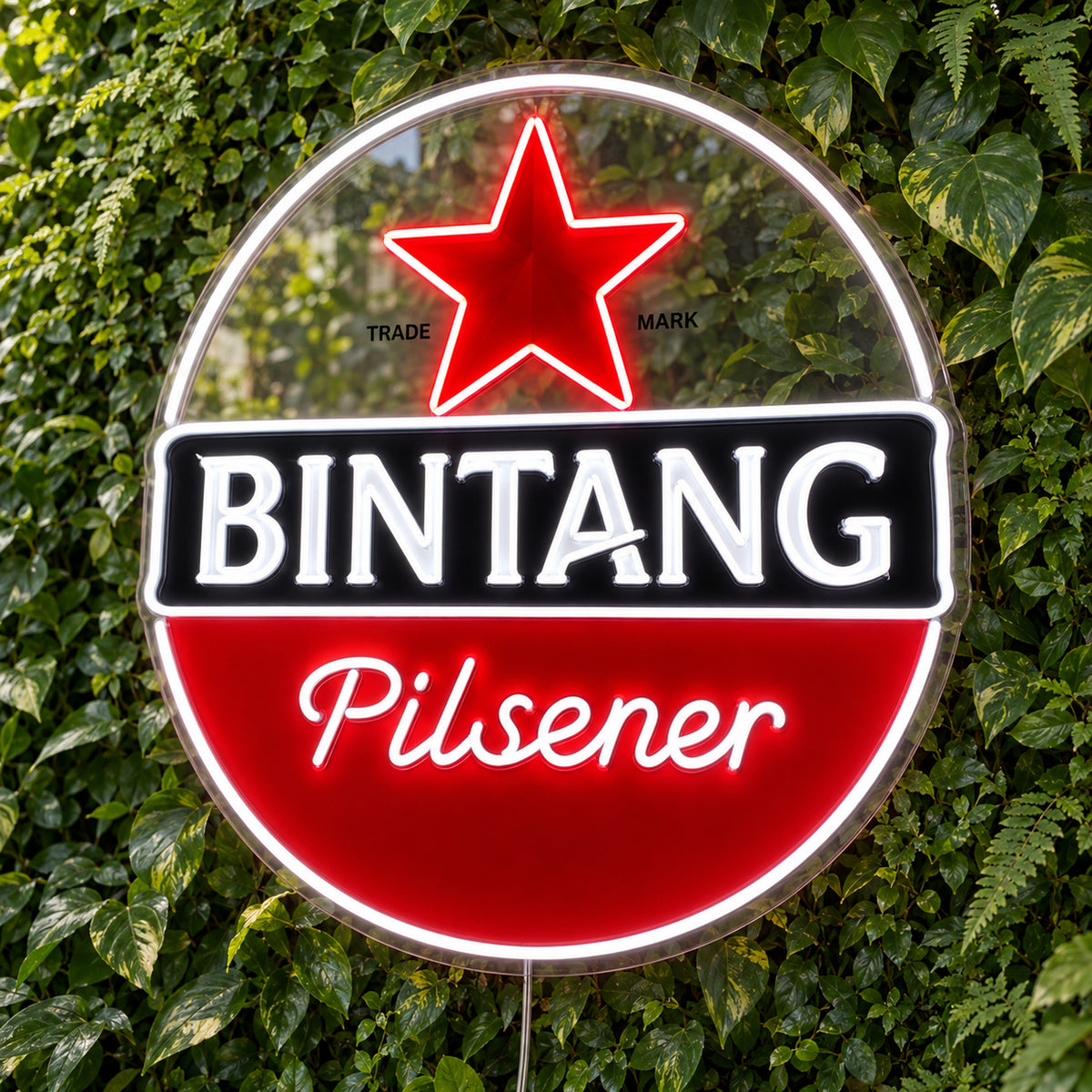 Bintang Pilsener LED Neon Sign, featuring beer-brand logo displayed on a green foliage wall.