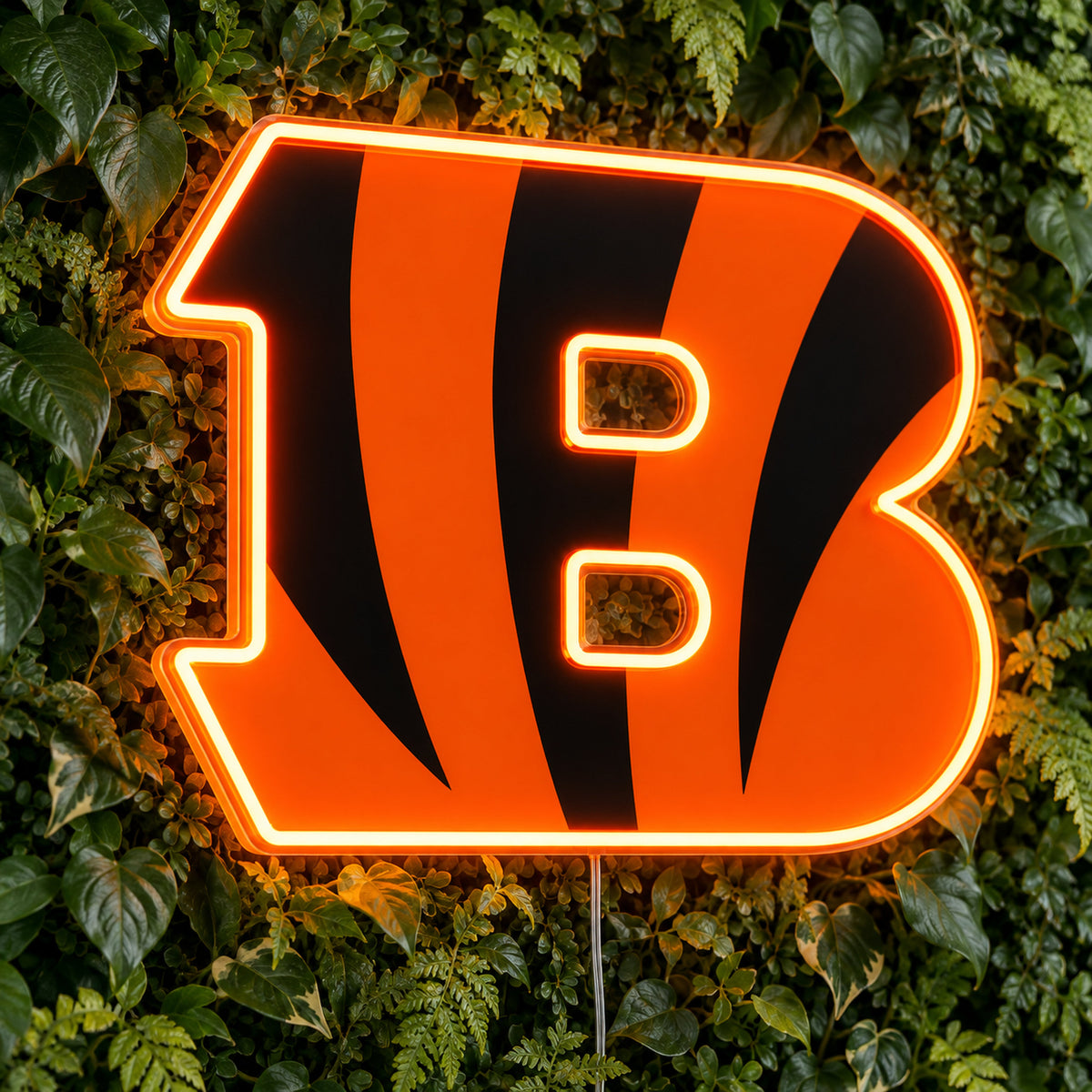 Cincinnati Bengals LED Neon Sign, featuring illuminated team logo on a green foliage wall.