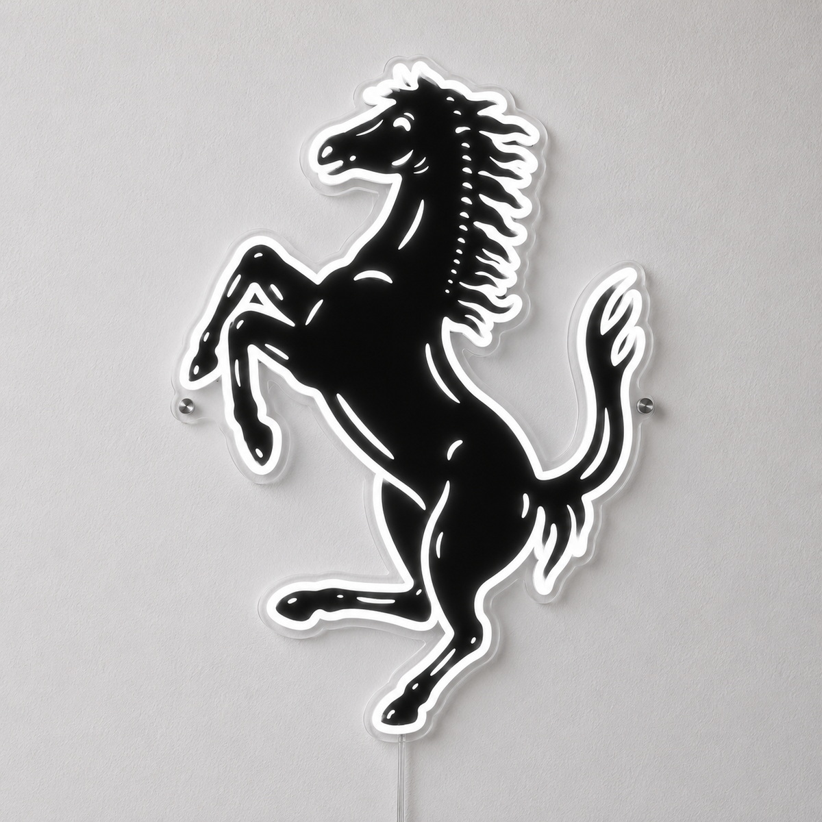 A black and white Ferrari prancing horse wall sign mounted on a light gray wall.