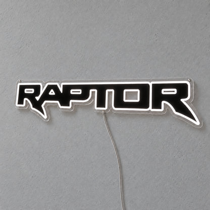 Ford Ranger Raptor LED Neon Sign in white, featuring outlined Raptor lettering on a grey wall.
