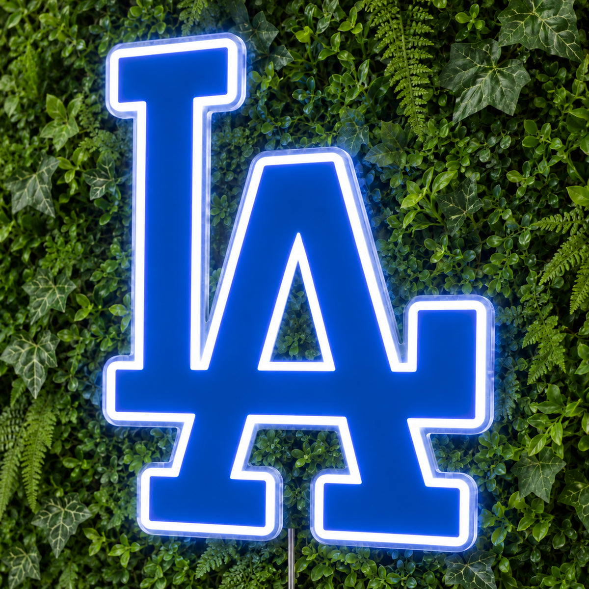 LA Dodgers LED Neon Sign, featuring team logo displayed on a green foliage wall.