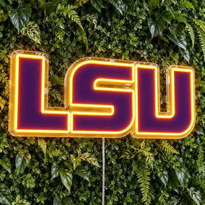 LSU Tigers LED Neon Sign, featuring team logo displayed on a green foliage wall.