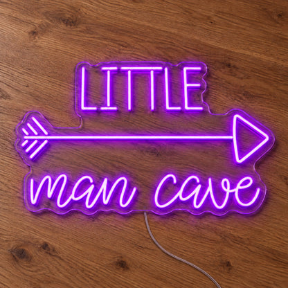 Little Man Cave LED Neon Sign in purple, featuring Little Man Cave lettering with an arrow on a wooden surface.