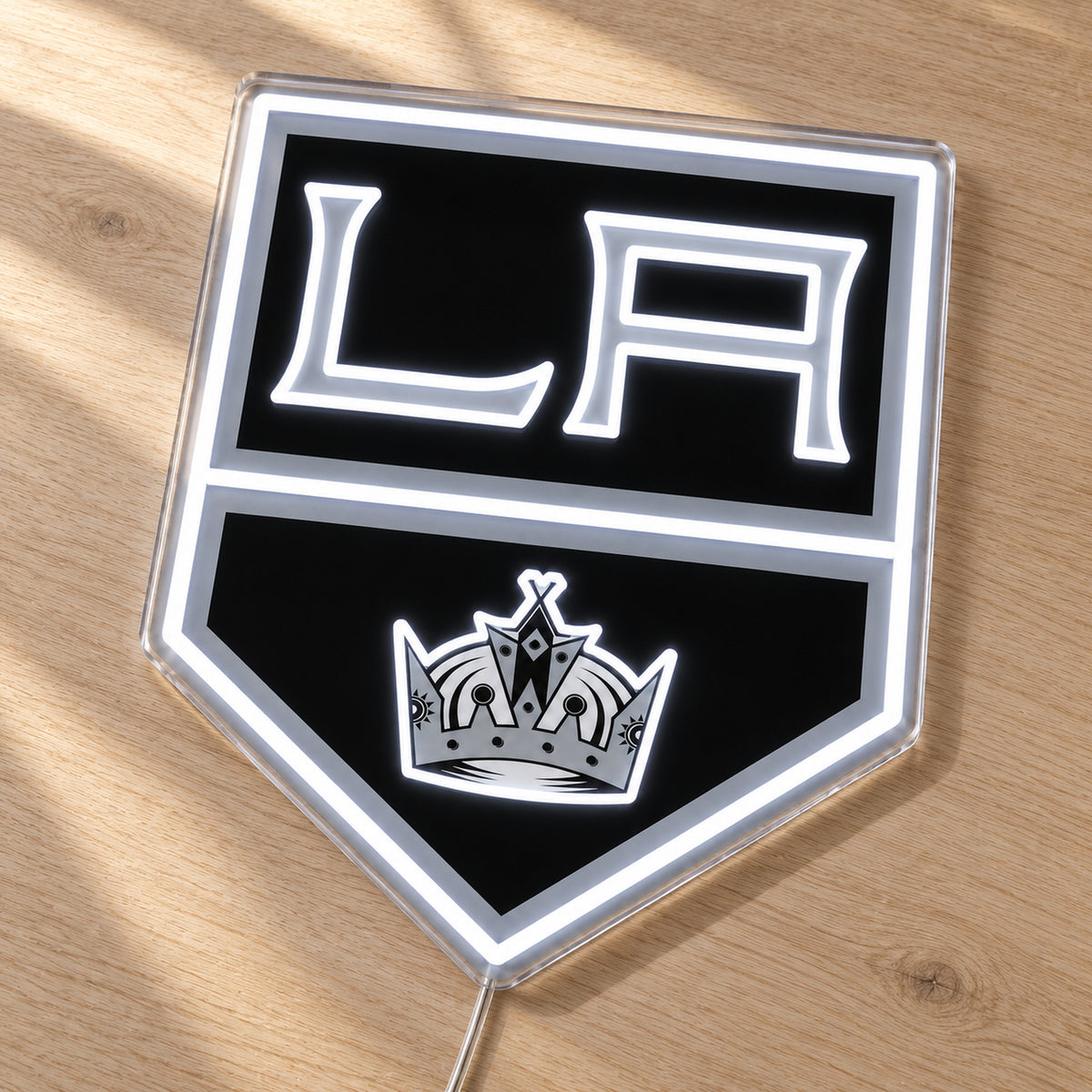 Los Angeles Kings LED Neon Sign, featuring team logo displayed on a wooden surface.