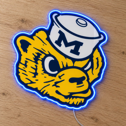 Michigan Wolverines Retro Mascot LED Neon Sign, featuring team logo displayed on a wooden surface.