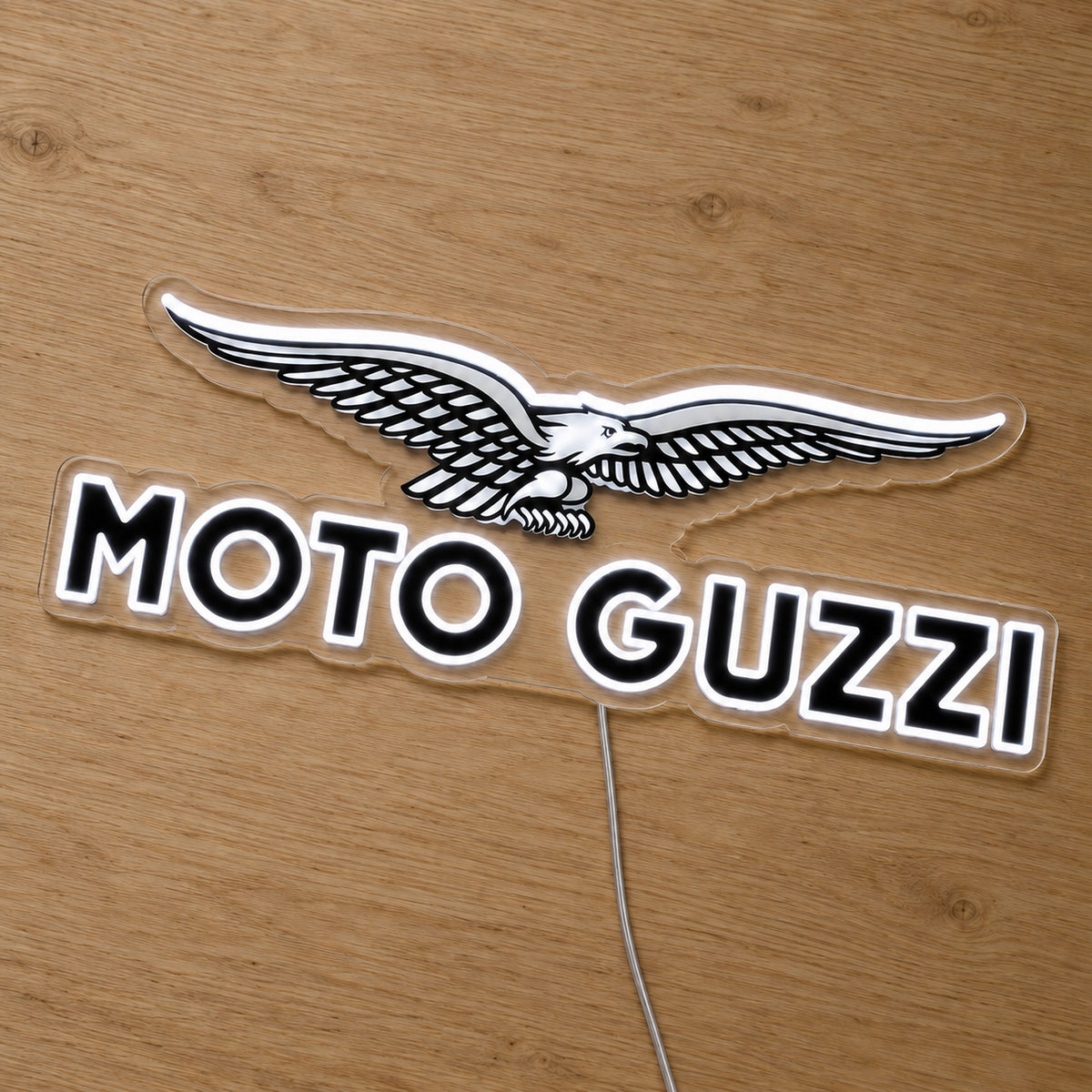 Moto Guzzi LED Neon Sign, featuring illuminated vehicle logo on a wooden surface.