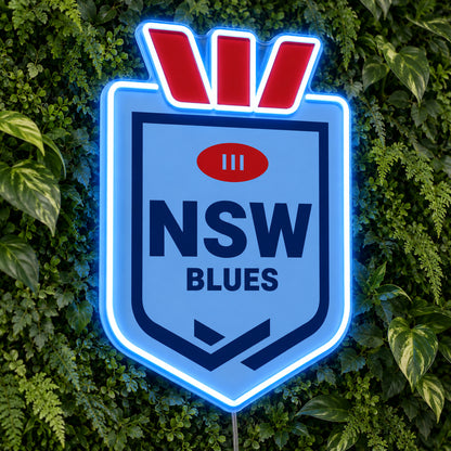 NSW Blues (Shield) LED Neon Sign, featuring illuminated team logo on a green foliage wall.