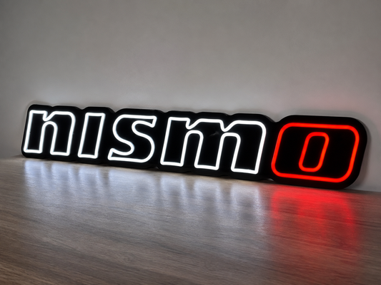 Neon sign with 'NISMO' logo on a wooden surface