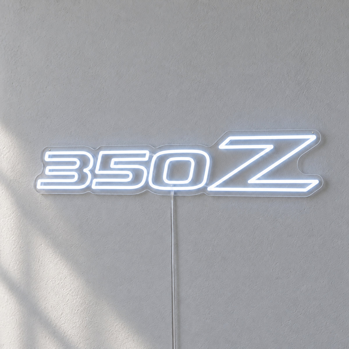 Nissan 350Z LED Neon Sign in white, featuring 350Z lettering on a grey wall.