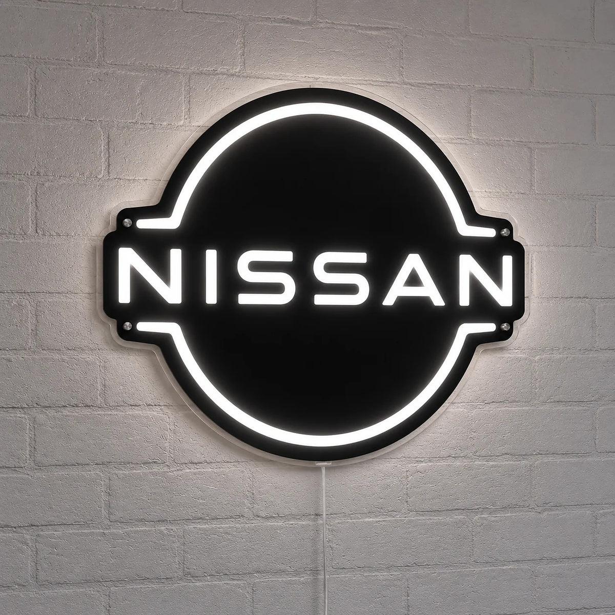 Nissan Neon Sign in white, featuring Nissan circle logo on a white brick wall.