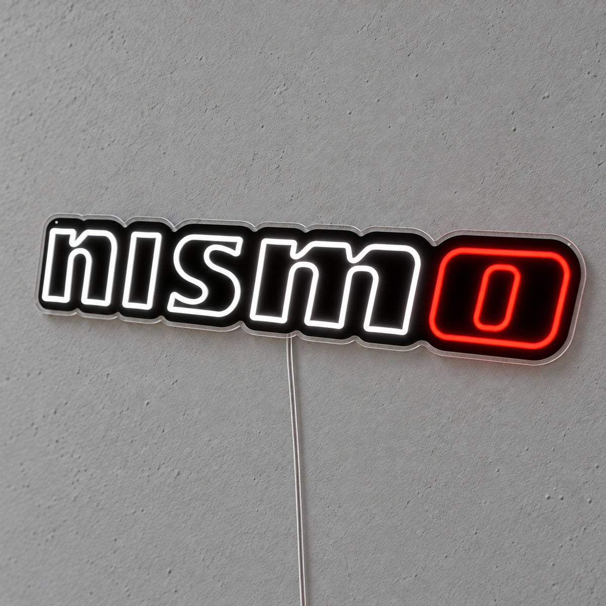 Nissan Nismo LED Neon Sign in white and red, featuring Nismo lettering on a grey wall.