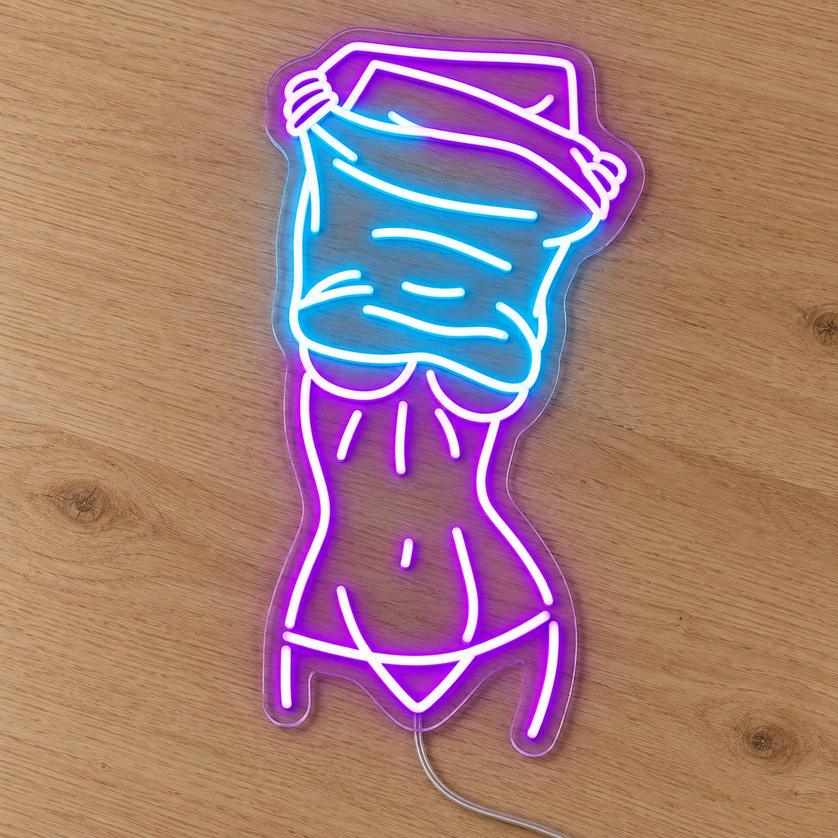 Nude Lady Man Cave Neon Sign - Garage & Home Bar Wall Sign in purple and turquoise, featuring a woman's outline on a wooden surface.
