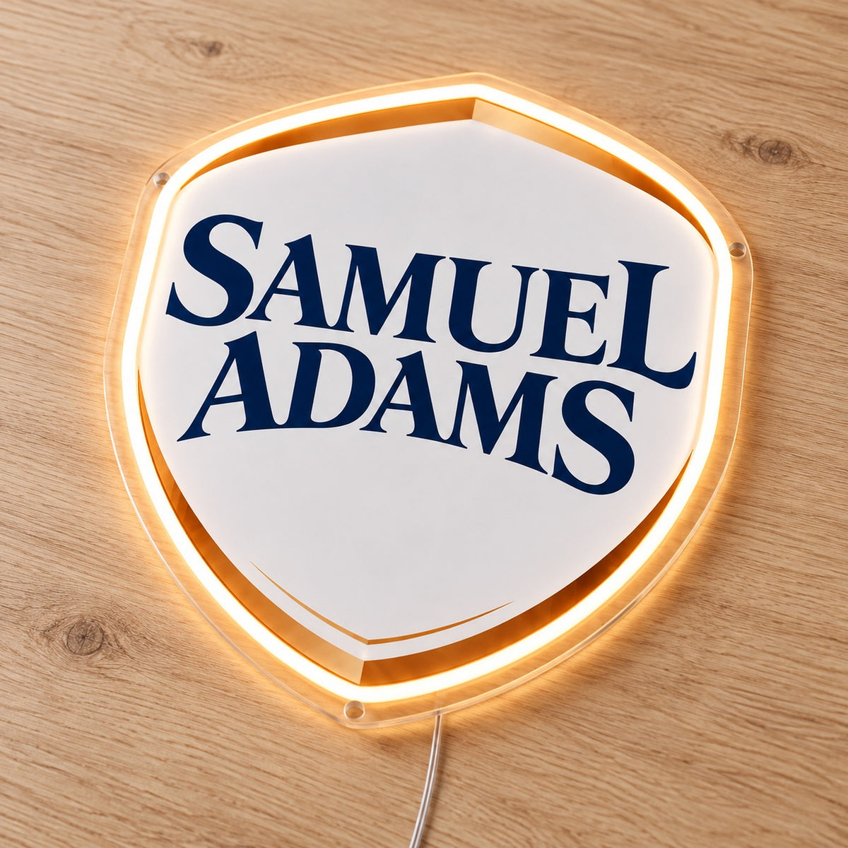 Samuel Adams LED Neon Sign, featuring illuminated beer-brand logo on a wooden surface.