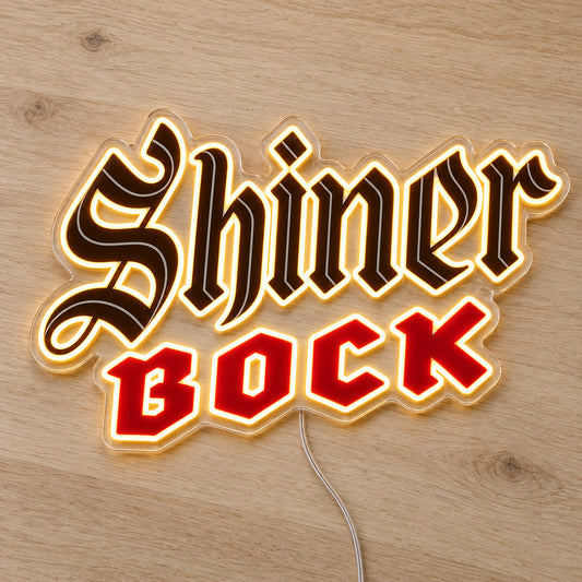 Shiner Bock LED Neon Sign, featuring illuminated beer-brand logo on a wooden surface.