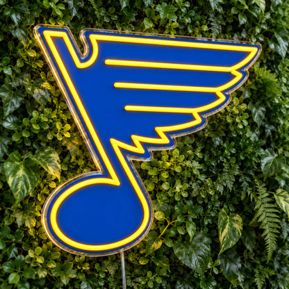 St Louis Blues LED Neon Sign, featuring team logo displayed on a green foliage wall.