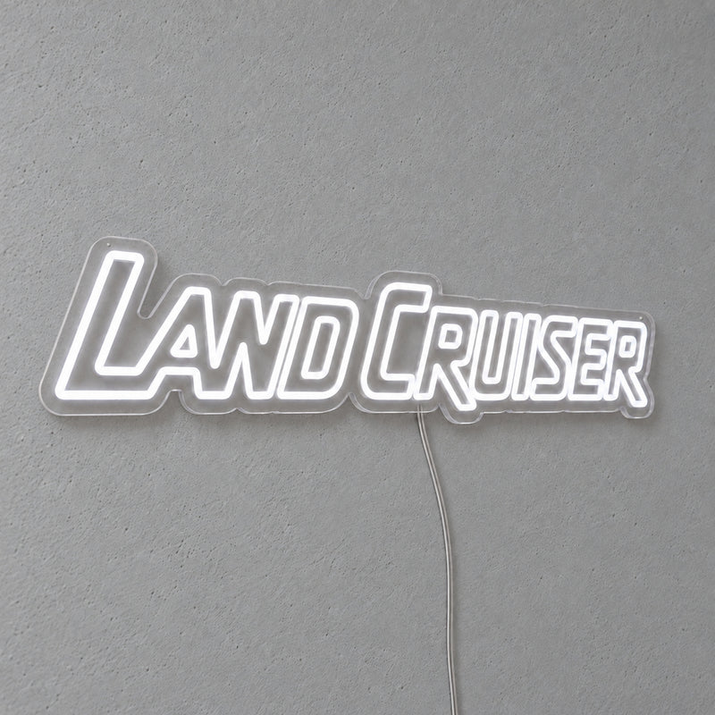 Toyota Land Cruiser LED Neon Sign in white, featuring Land Cruiser lettering on a grey wall.