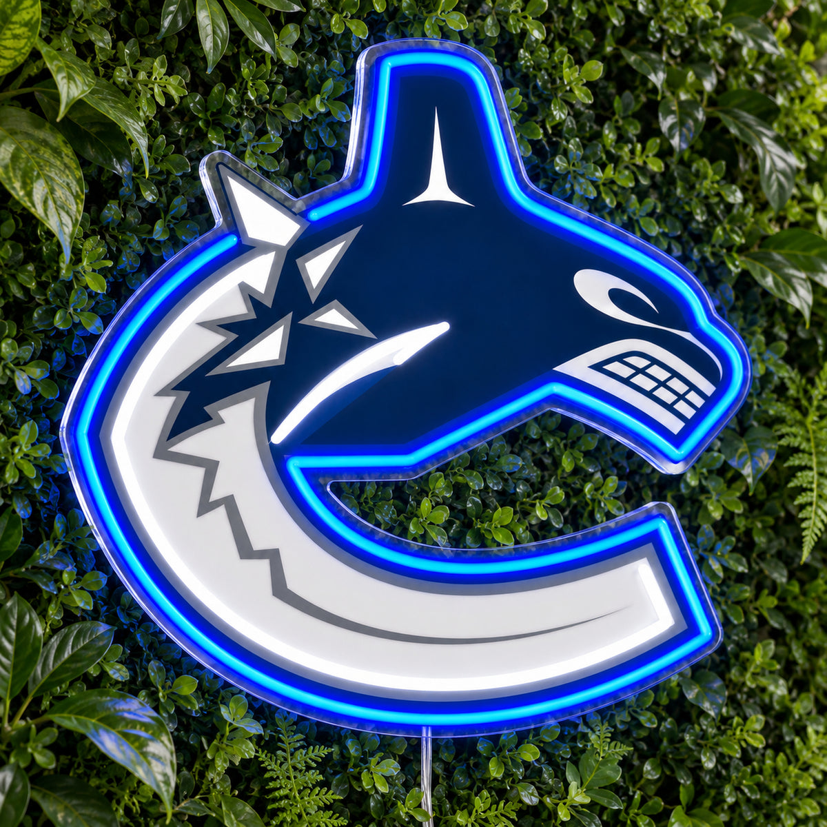 Vancouver Canucks LED Neon Sign, featuring team logo displayed on a green foliage wall.