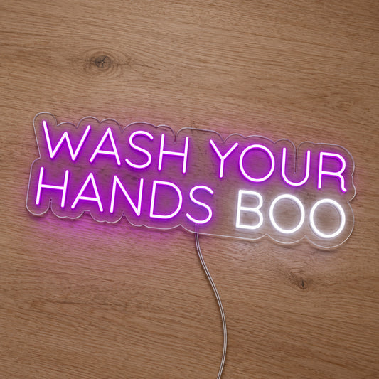 Wash Your Hands Boo LED Neon Sign in pink and white, featuring Wash Your Hands Boo lettering on a wooden surface.