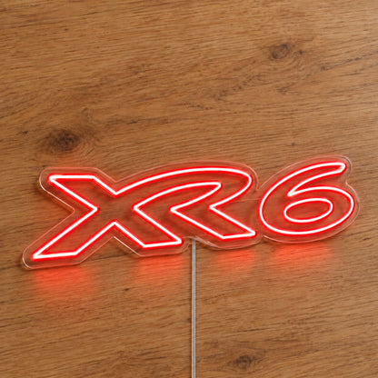 XR6 Ford Falcon LED Neon Sign in red, featuring XR6 lettering on a wooden surface.