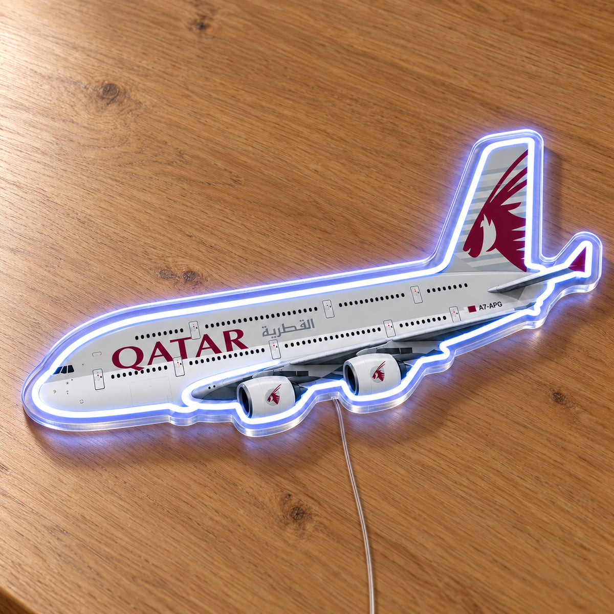 Airbus A380 Qatar Airways Neon Sign with printed aircraft details and an illuminated LED outline on clear acrylic, shown on a wooden surface, registration A7-APG