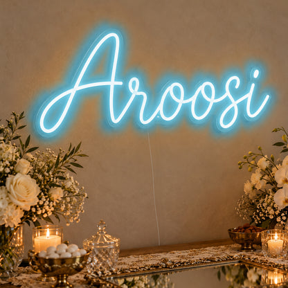 Aroosi Neon Sign in ice blue LED neon on clear acrylic, angled view