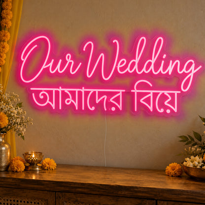 Our Wedding English & Bengali Neon Sign in rose red LED neon on clear acrylic, angled view