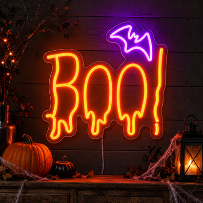 Boo Bat Neon Sign featuring orange dripping Boo lettering topped with a purple bat, glowing on a dark wall in a Halloween room display.