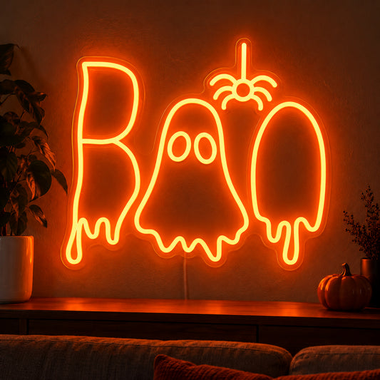 Boo Ghost and Spider Neon Sign featuring orange Boo lettering with a white ghost in the centre and a hanging orange spider, displayed on a dark wall above a wooden sideboard.