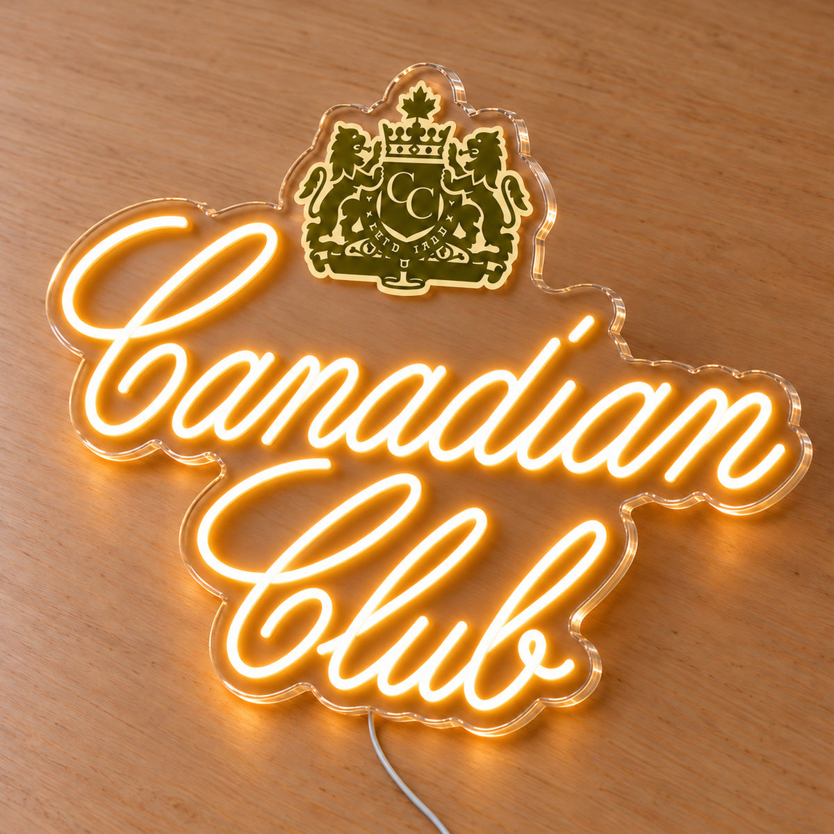 Canadian Club LED neon sign on a light wooden surface, second angled view