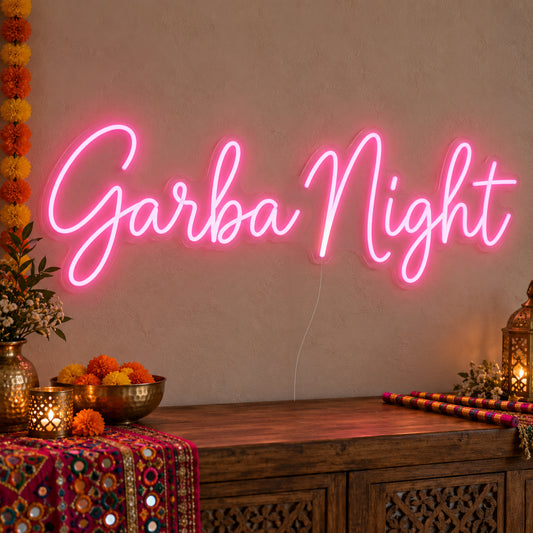 Garba Night Neon Sign on clear cut-to-shape acrylic, illuminated on a wall in a styled celebration setting