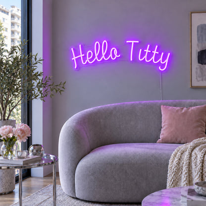 Hello Titty Neon Sign with purple lighting, displayed above a curved grey sofa.