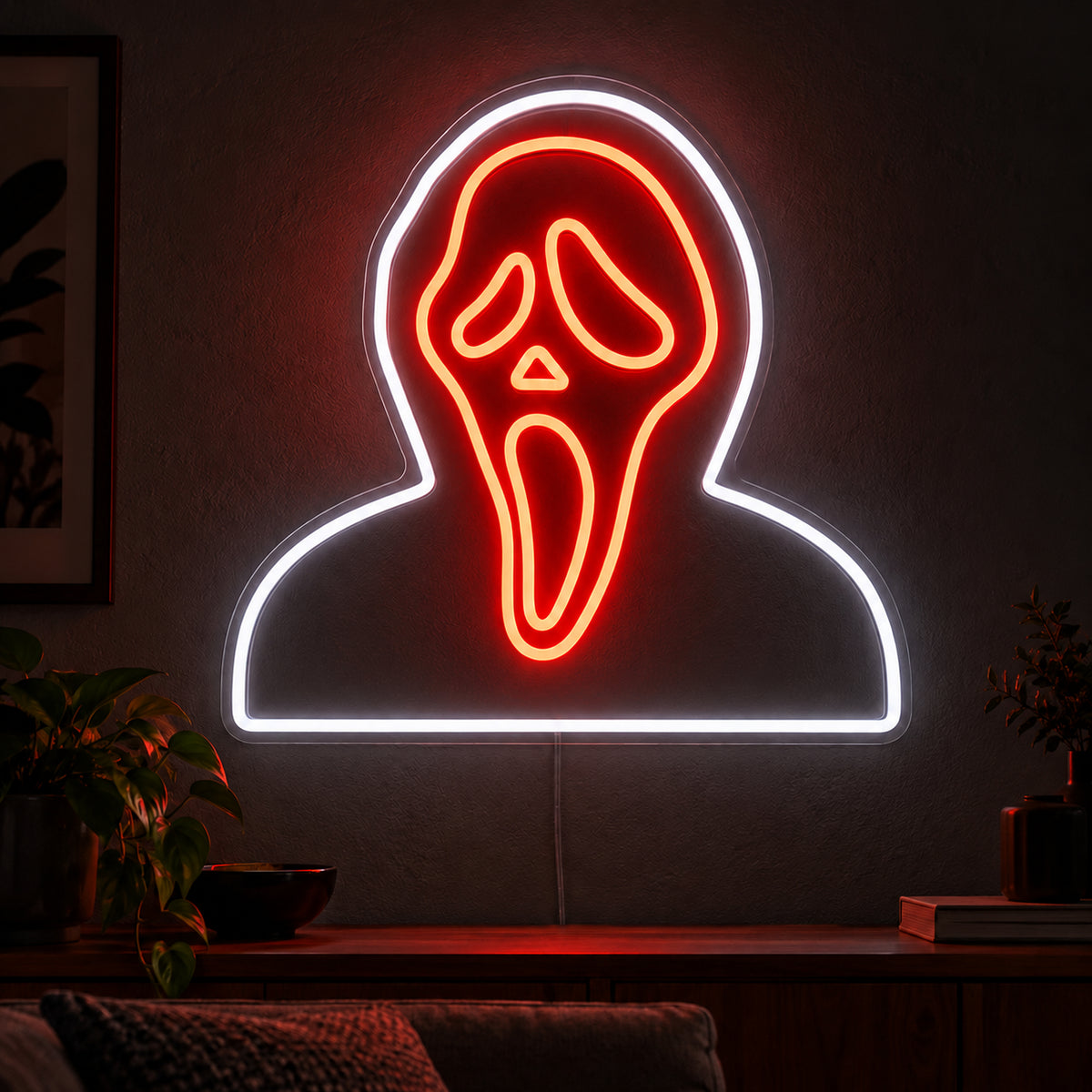 Hooded Ghostface Neon Sign featuring an orange Ghostface mask framed by a white hood and shoulder outline, displayed on a dark wall above a wooden sideboard.