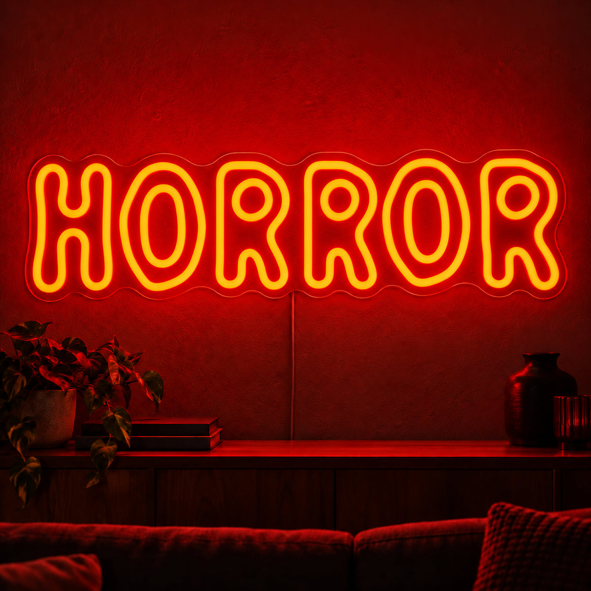Horror Rounded Letters Neon Sign featuring the word Horror in rounded orange outline letters, displayed on a dark wall above a wooden sideboard.