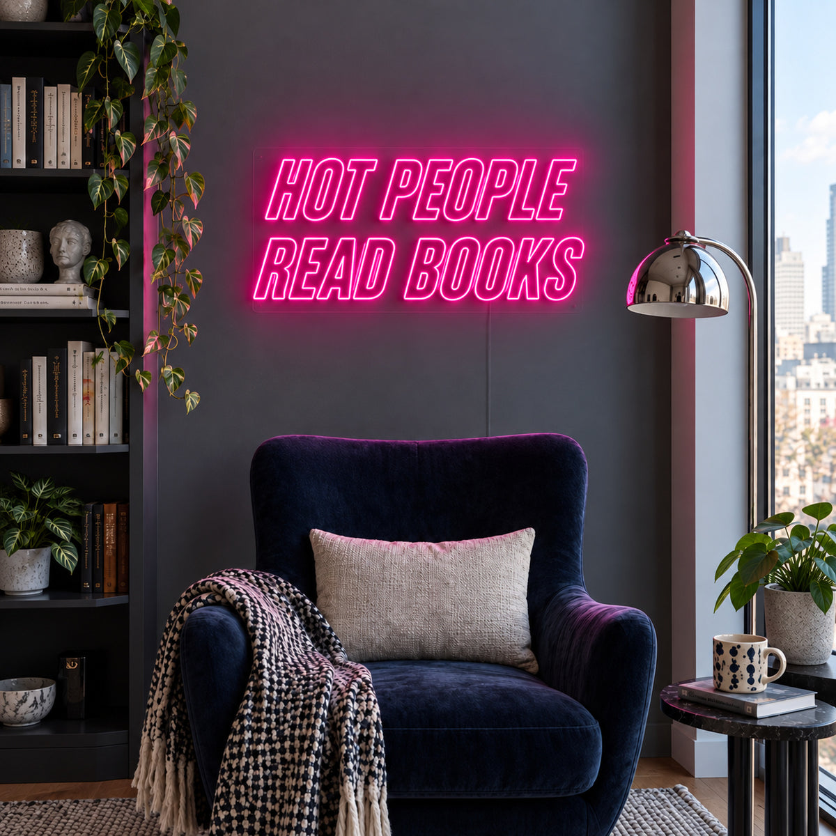 Rose Red version of the Hot People Read Books Neon Sign, shown above a blue reading chair.