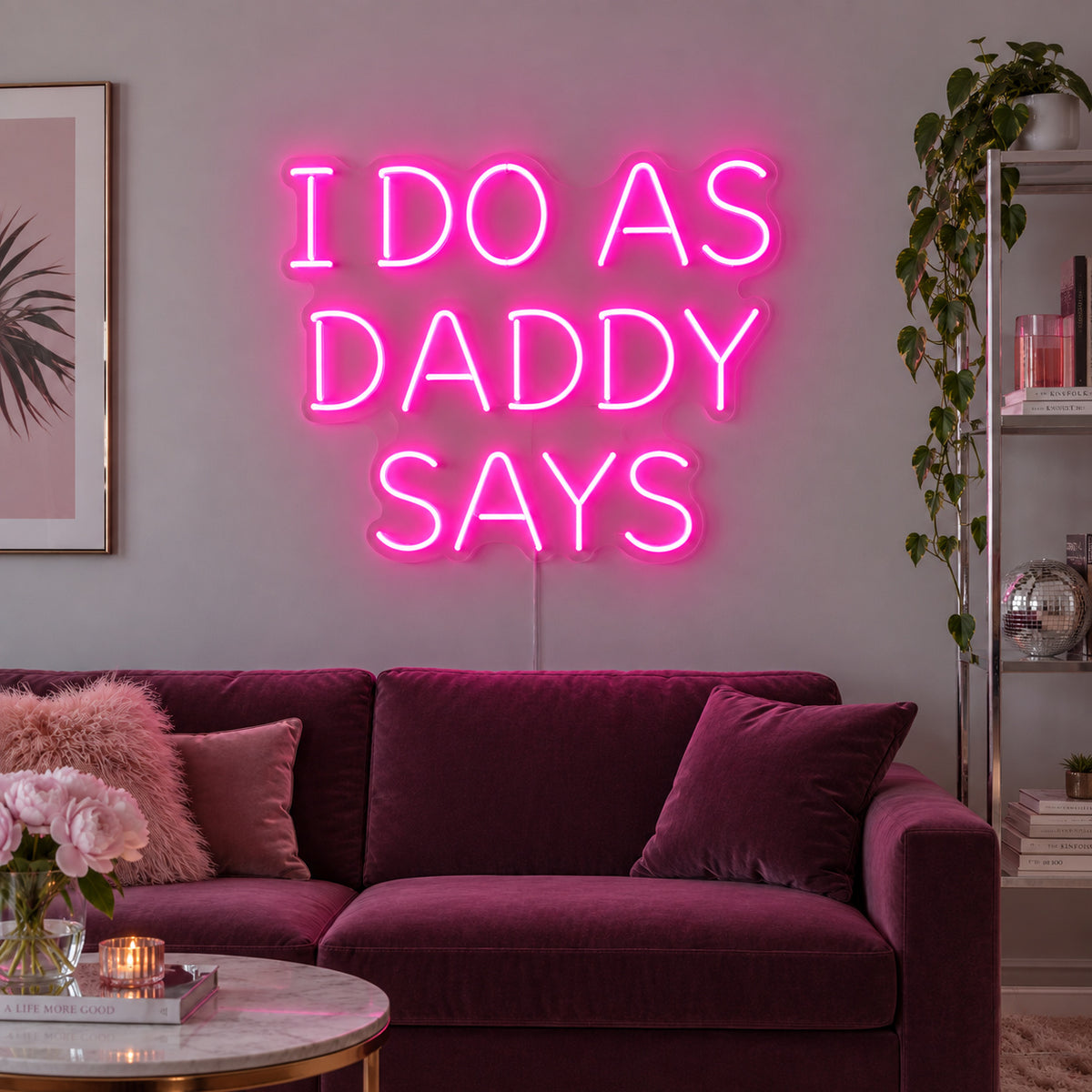 Rose Red version of the I Do As Daddy Says Neon Sign, shown above a burgundy sofa.