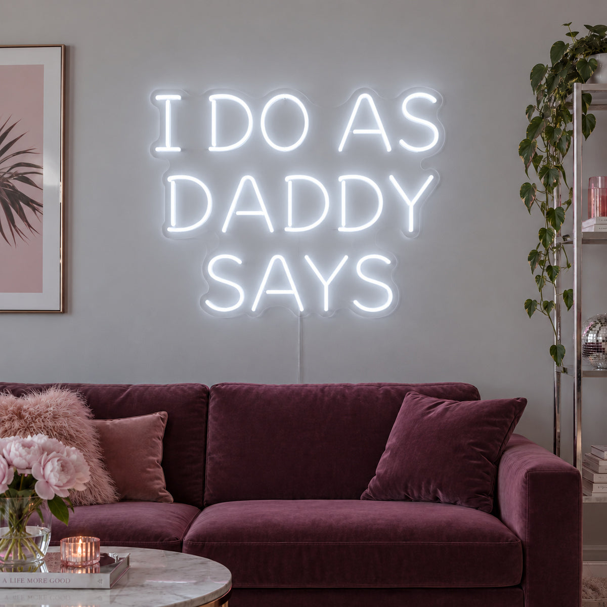 I Do As Daddy Says Neon Sign glowing white above a burgundy sofa.