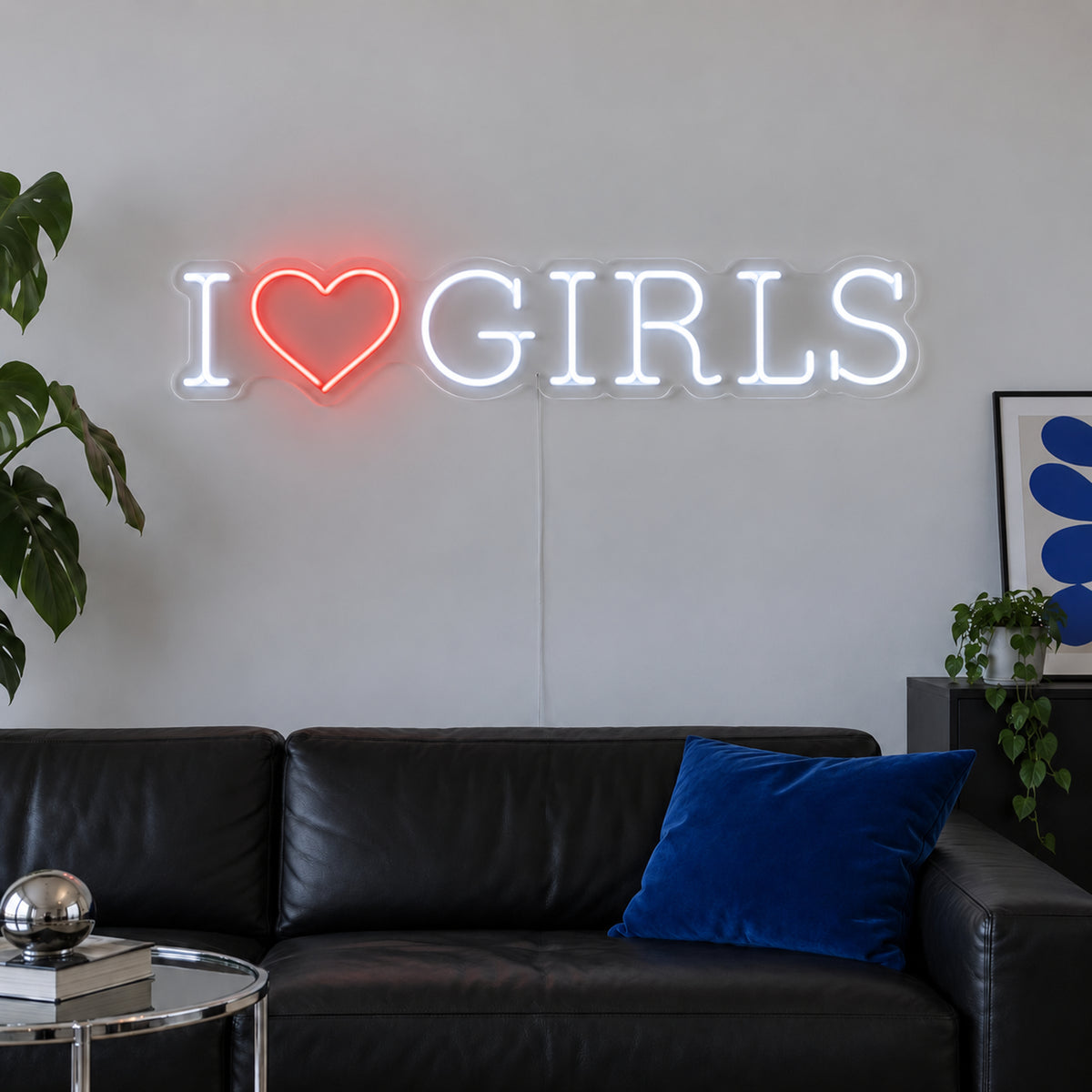 I Love Girls Neon Sign with white lettering with a red heart in a horizontal layout on transparent acrylic, displayed on a living room wall