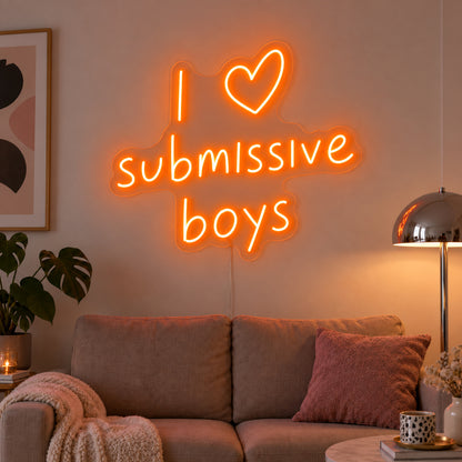 Orange version of the I Love Submissive Boys Neon Sign, shown above a neutral sofa.