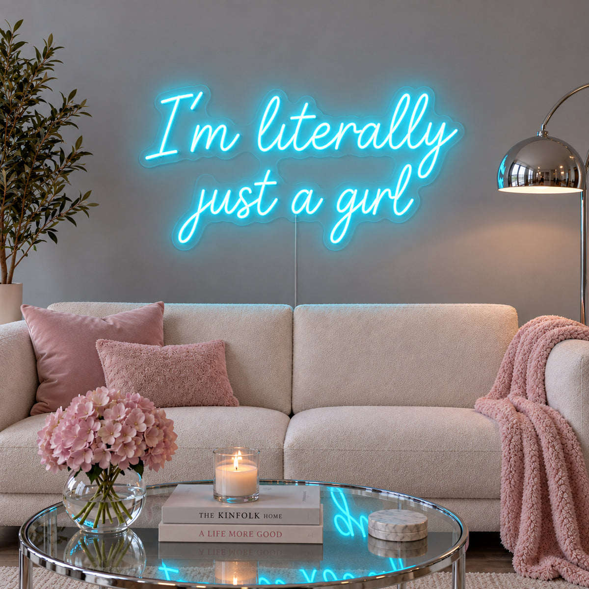 Ice Blue version of the I'm Literally Just A Girl Neon Sign, shown above a cream sofa.