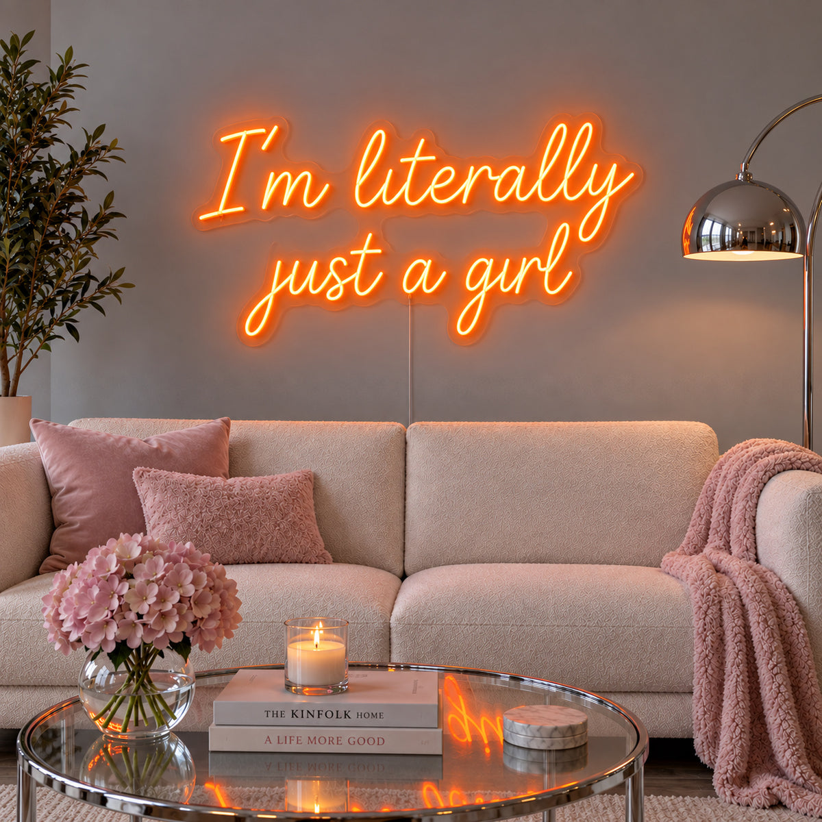 Orange version of the I'm Literally Just A Girl Neon Sign, shown above a cream sofa.