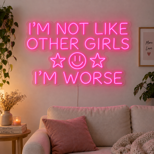 I'm Not Like Other Girls I'm Worse Neon Sign in rose red with stars and a smiley face above a cream sofa.