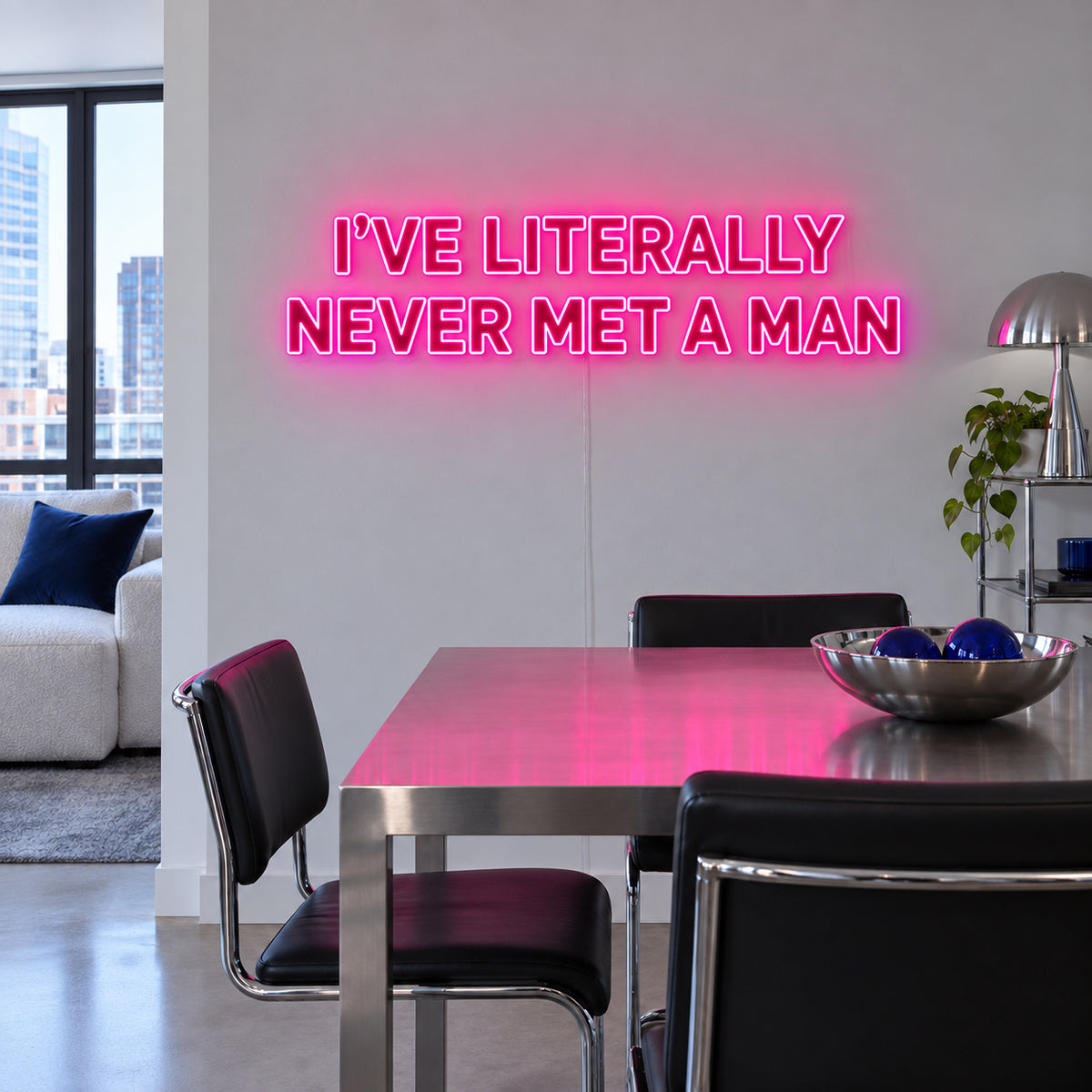 Rose Red version of the I've Literally Never Met A Man Neon Sign, shown above a dining table.